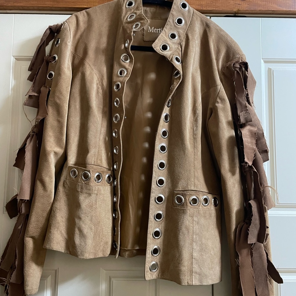 Nice vintage tan jacket with grommets and fringe.